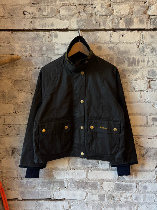 Women's Barbour Cropped Beadnell Waxed Jacket in navy, featuring a classic style with a cropped fit and waxed finish.