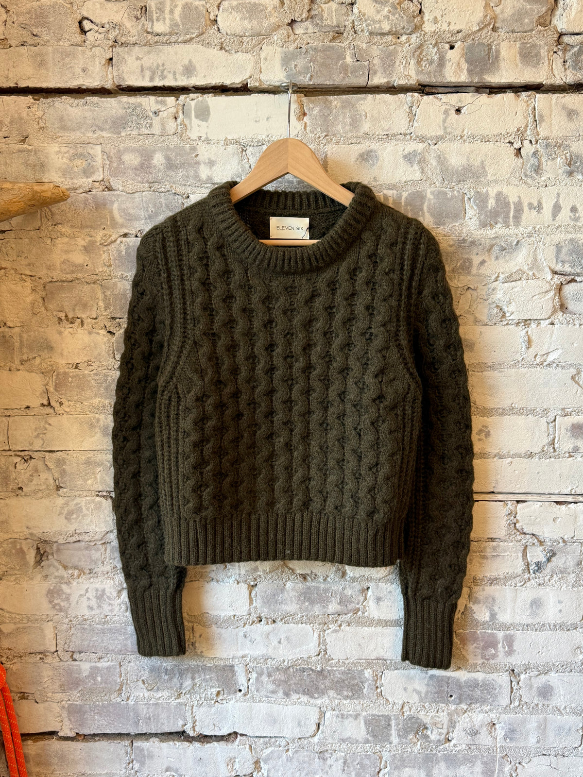 Women's Amara Sweater by ELEVEN SIX in dark olive, cozy knit with long sleeves and ribbed cuffs, stylish and comfortable.