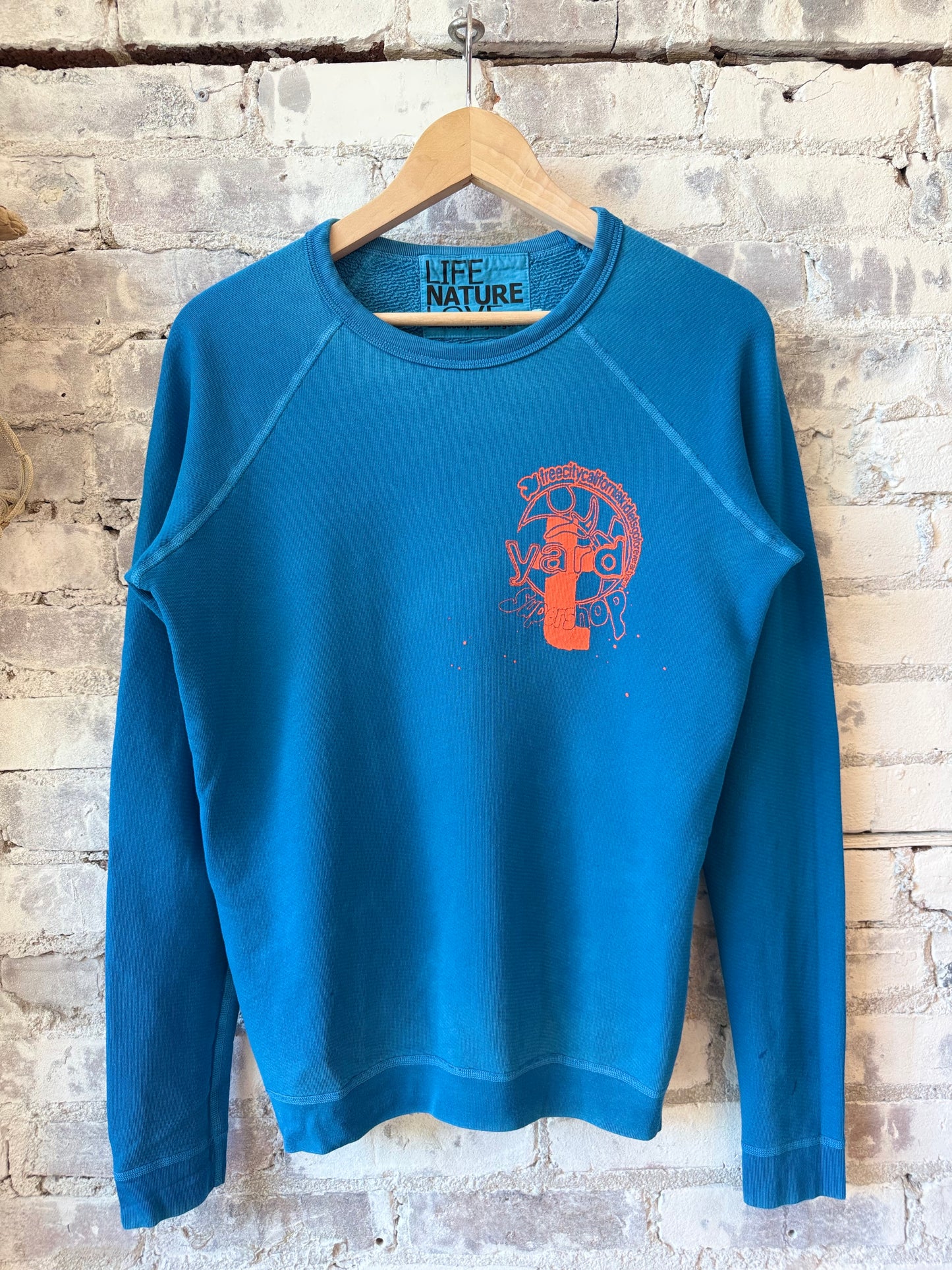 Women's Krishna Blue raglan sweatshirt by Freecity featuring ARTYARD/SUPERSHOP stamp design and relaxed fit.