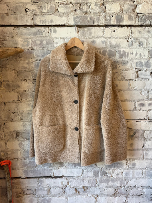 Women's Isabella Reversible Shearling Jacket in Sand by ARMA, showing the cozy shearling lining and stylish outer fabric.