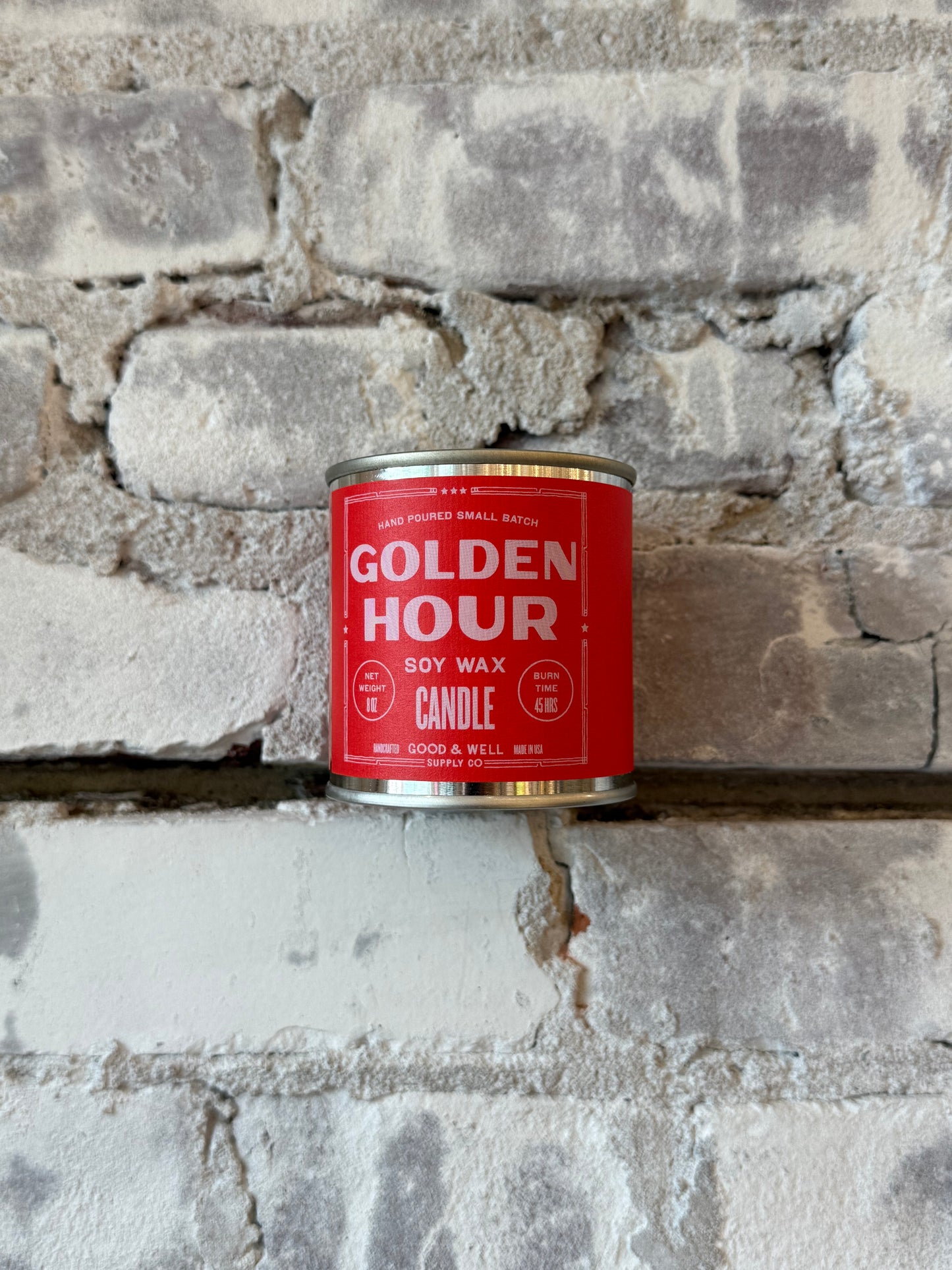 Golden Hour soy candle by Good & Well Supply Co. in a glass jar, emitting a warm, inviting glow as a home accessory.