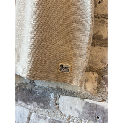 Men's Kepani Raffy Pique Knit Polo Shirt in oatmeal, featuring a classic collar and short sleeves, laid flat on a white background.