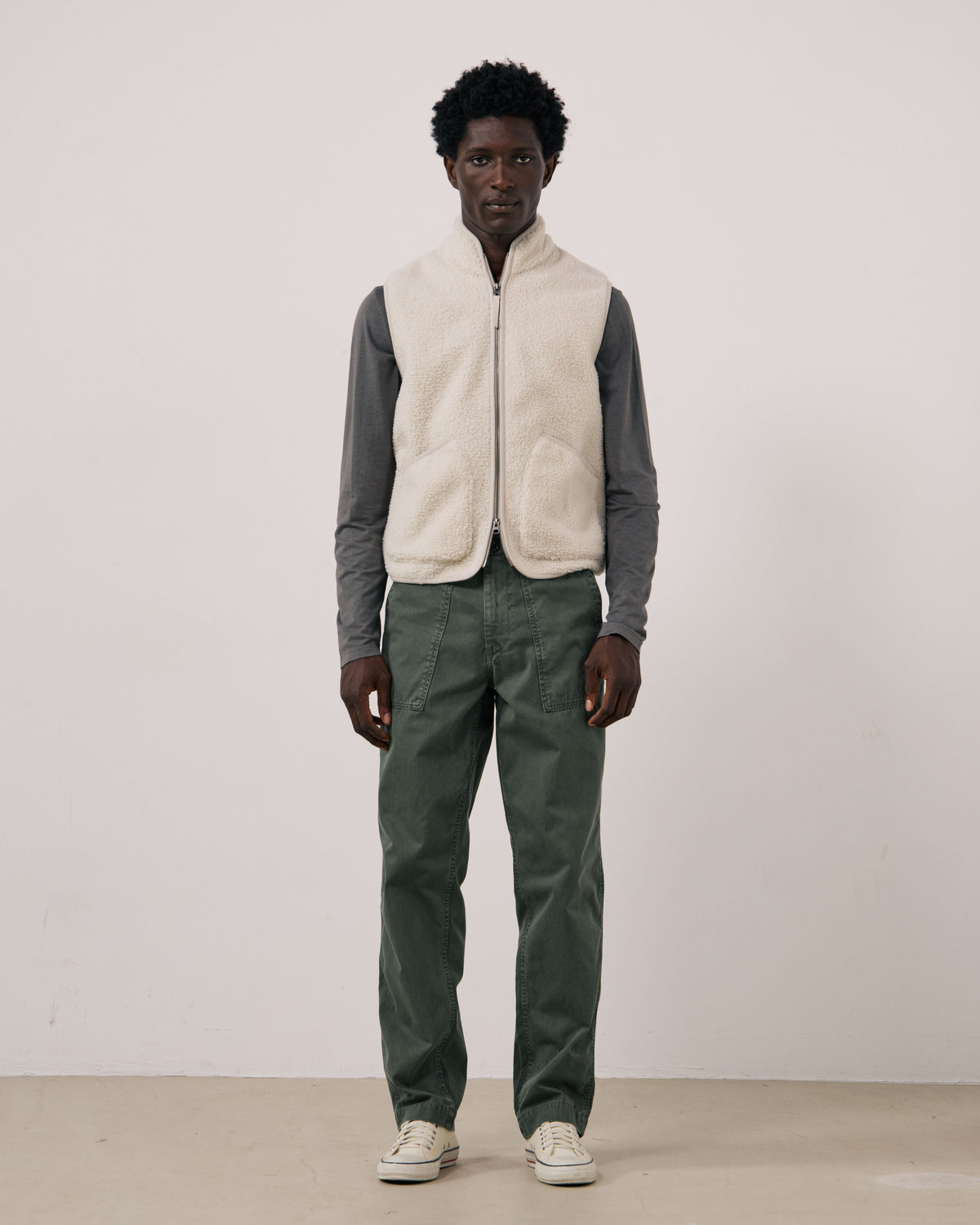Hartford Men's Basta knitted vest in natural color, shown on a mannequin, featuring a cozy, ribbed knit design and V-neck style.