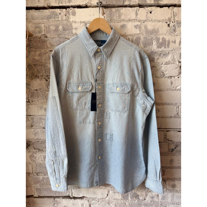 Men's Polo RL chambray compass workshirt in medium indigo, featuring a button-up design and casual workwear style.