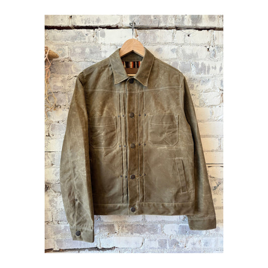 Men's waxed canvas Riders Jacket in Tobacco Brown by Freenote Cloth, shown in a close-up of the textured, durable jacket fabric.