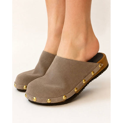 Brown clog shoe with gold studs on a white background