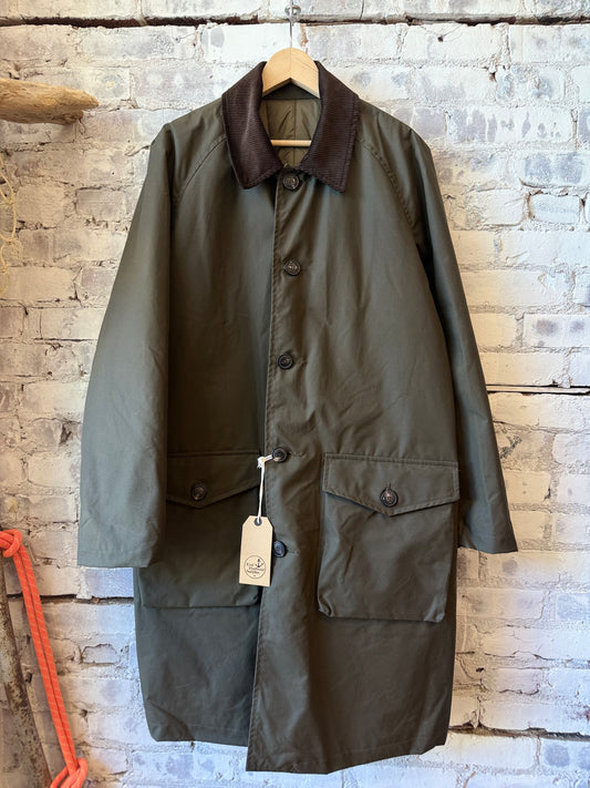 Men's green waxed cotton trench coat by East Harbour Surplus, stylish men's outerwear with a classic design and durable fabric.
