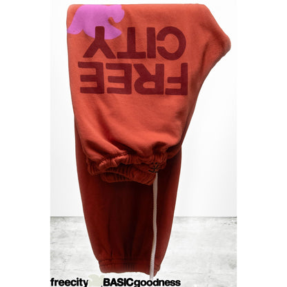 Women's Freecity large sweatpant in burn orange, relaxed fit with elastic waistband and cozy fabric for comfortable casual wear.