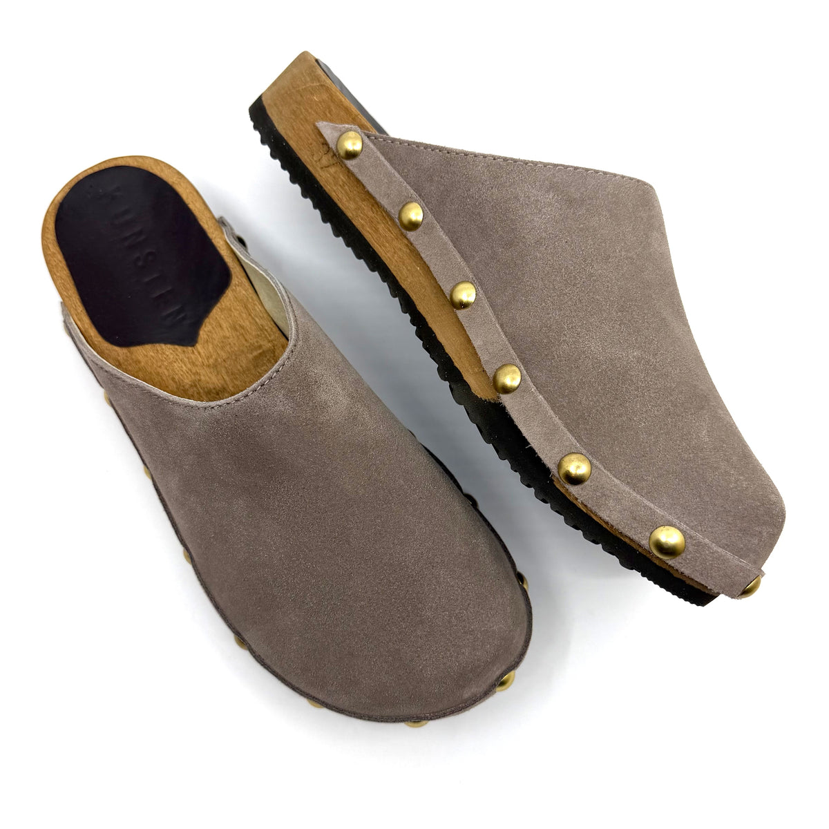 Pair of brown suede clogs with gold studs on a white background