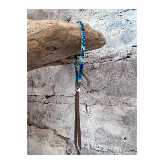 Blue mini bracelet from Julie Rofman jewelry line, featuring delicate design and small blue beads on a fine chain.
