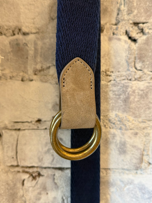 Navy cotton weave O-ring belt with bison tabs from W. Kleinberg, showing the textured fabric and metal ring closure.