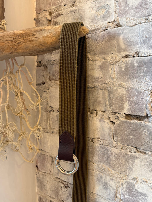 Men's olive woven O-ring belt with striped design and Sicily calf tabs by W. Kleinberg, showcasing the textured strap and hardware.