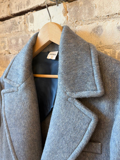 Women's sky blue wool coat by Aspesi, featuring a tailored fit and classic design, displayed hanging on a wooden hanger.