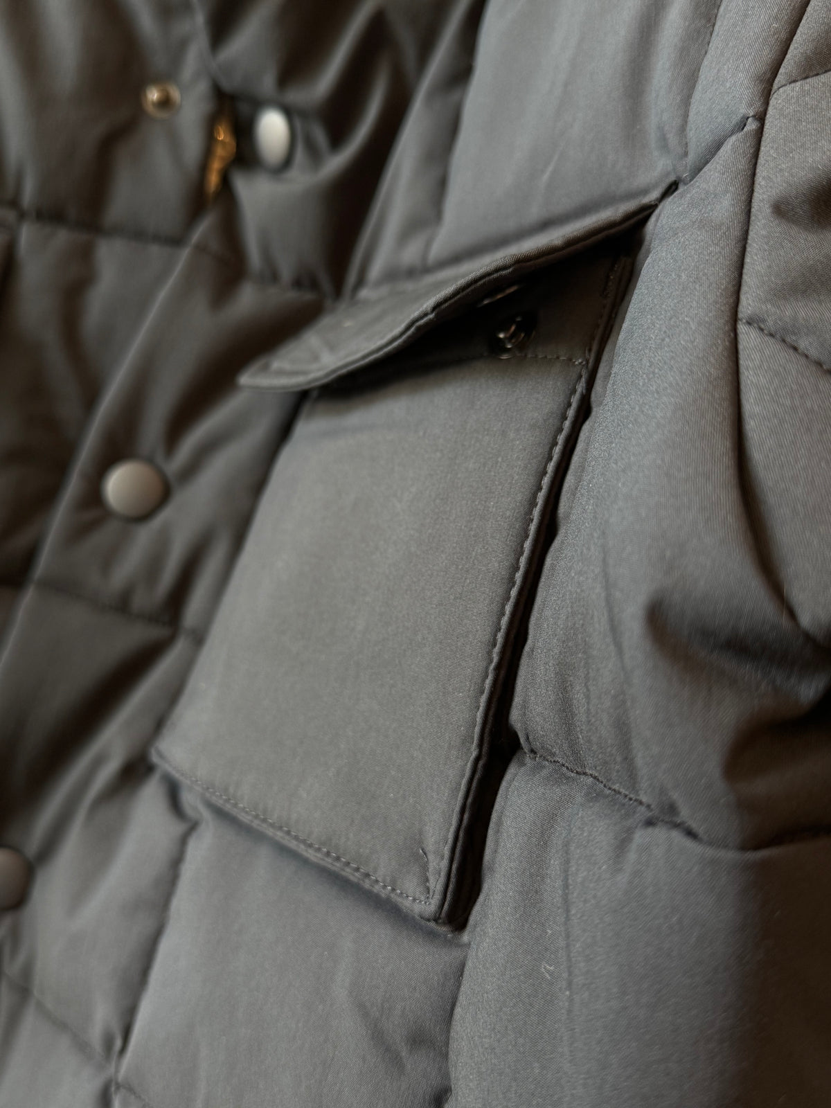 Men's navy padded quilted overshirt by Aspesi, showing the quilted fabric, padded design, and classic collar detail.