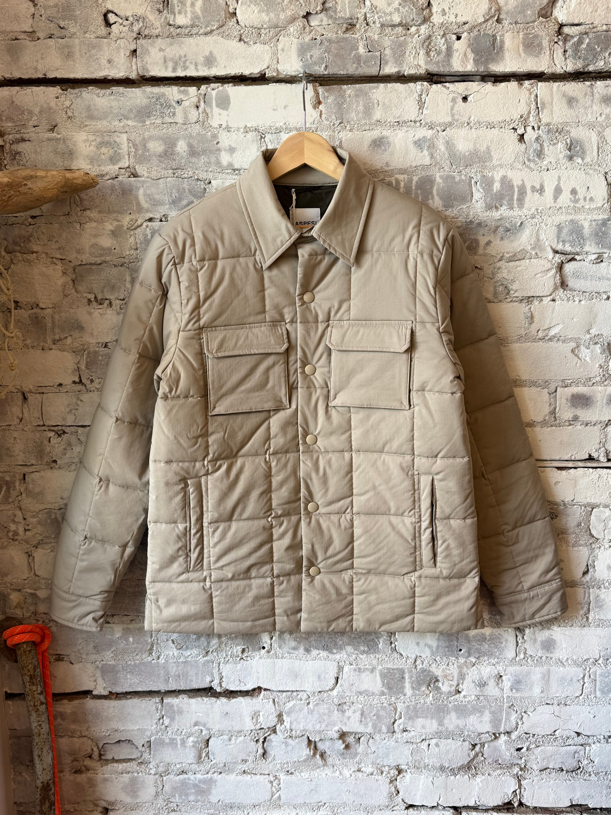 Men's padded quilted overshirt by Aspesi in colonial beige, showing the front view with quilted fabric and padded design.