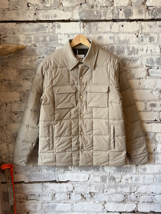 Men's padded quilted overshirt by Aspesi in colonial beige, showing the front view with quilted fabric and padded design.