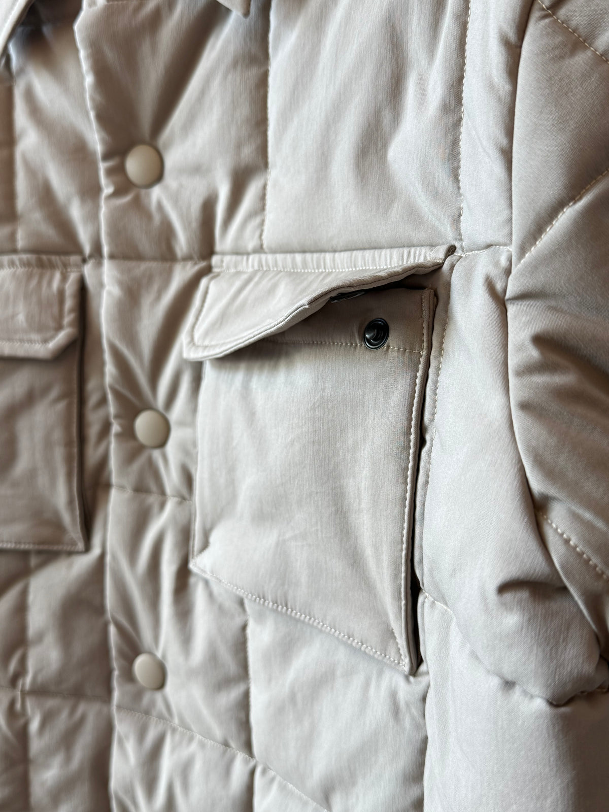 Men's padded quilted overshirt in colonial beige by Aspesi, showing the front view with quilted stitching and padded design.