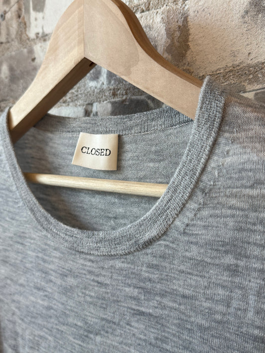 Close-up of a women's light grey melange pure wool fine knit sweater by Closed Women's, showing textured fabric and neckline.
