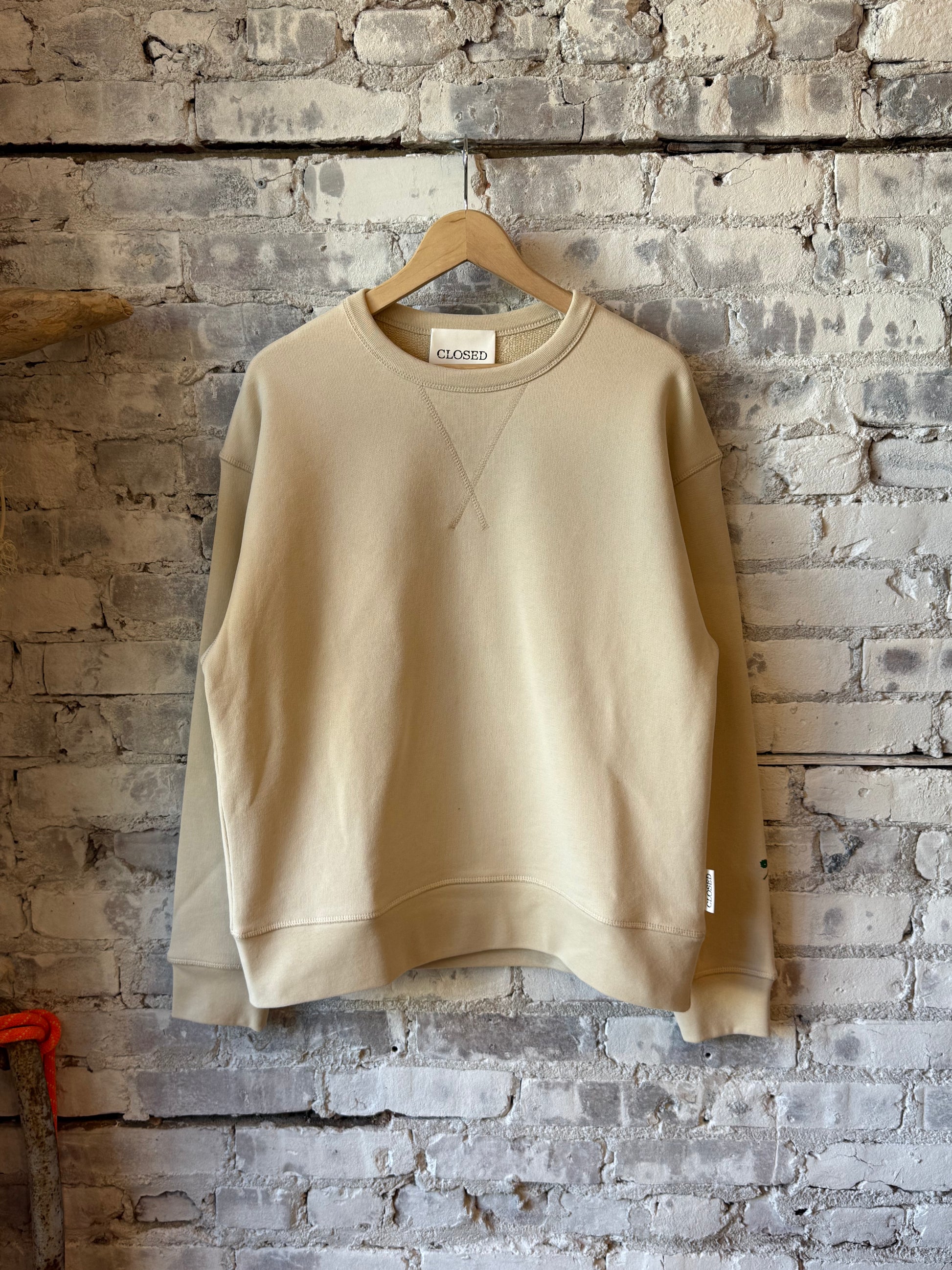 Men's almond cream crewneck sweatshirt by Closed Men's, showing a soft, casual knit fabric in a relaxed fit.