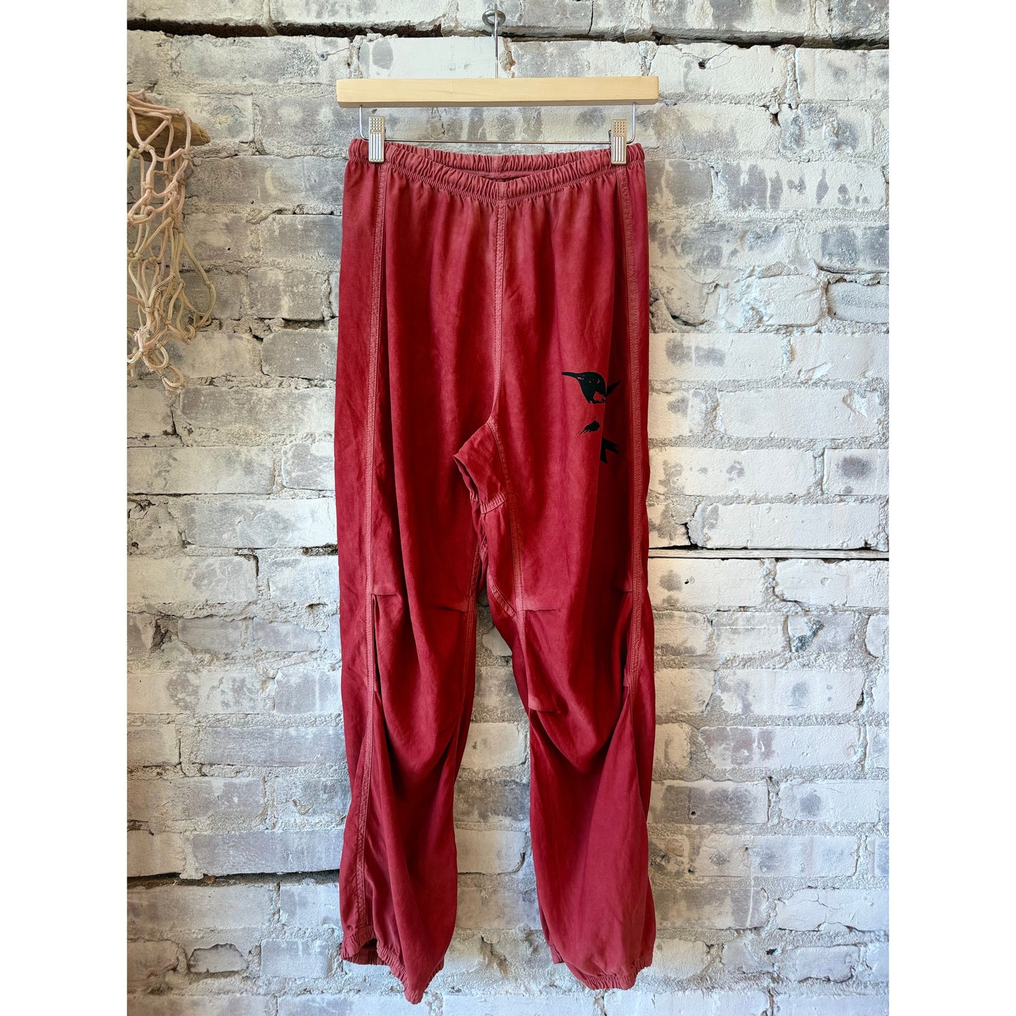 Women's loose drawcord Biggy pants in matte satin fabric by Freecity, shown in vibrant Artyard Red.