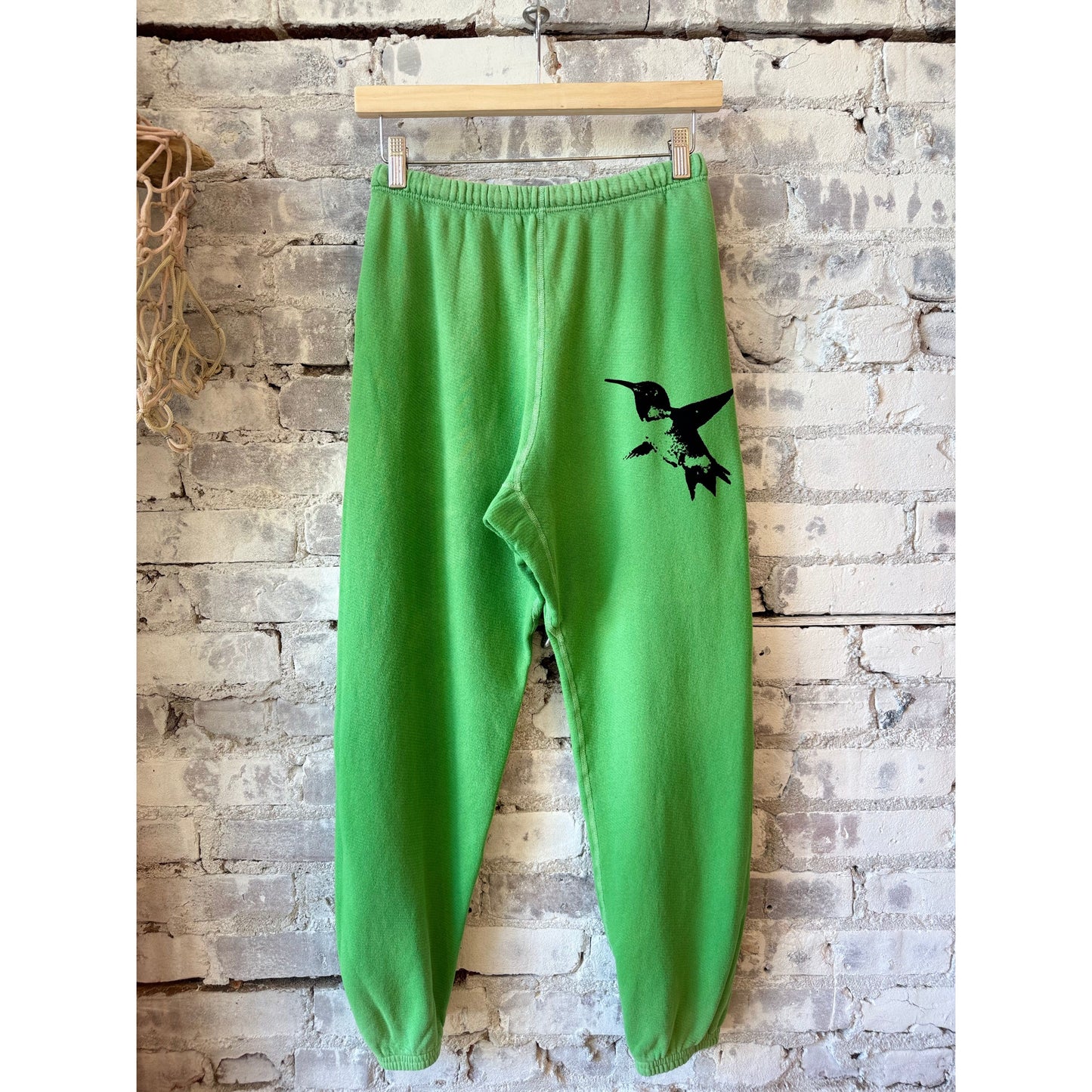 Women’s Freecity Sparrow 2005 SuperVintYumYum OG sweatpants in Grasshopper Powder, showcasing their relaxed fit and soft fabric.