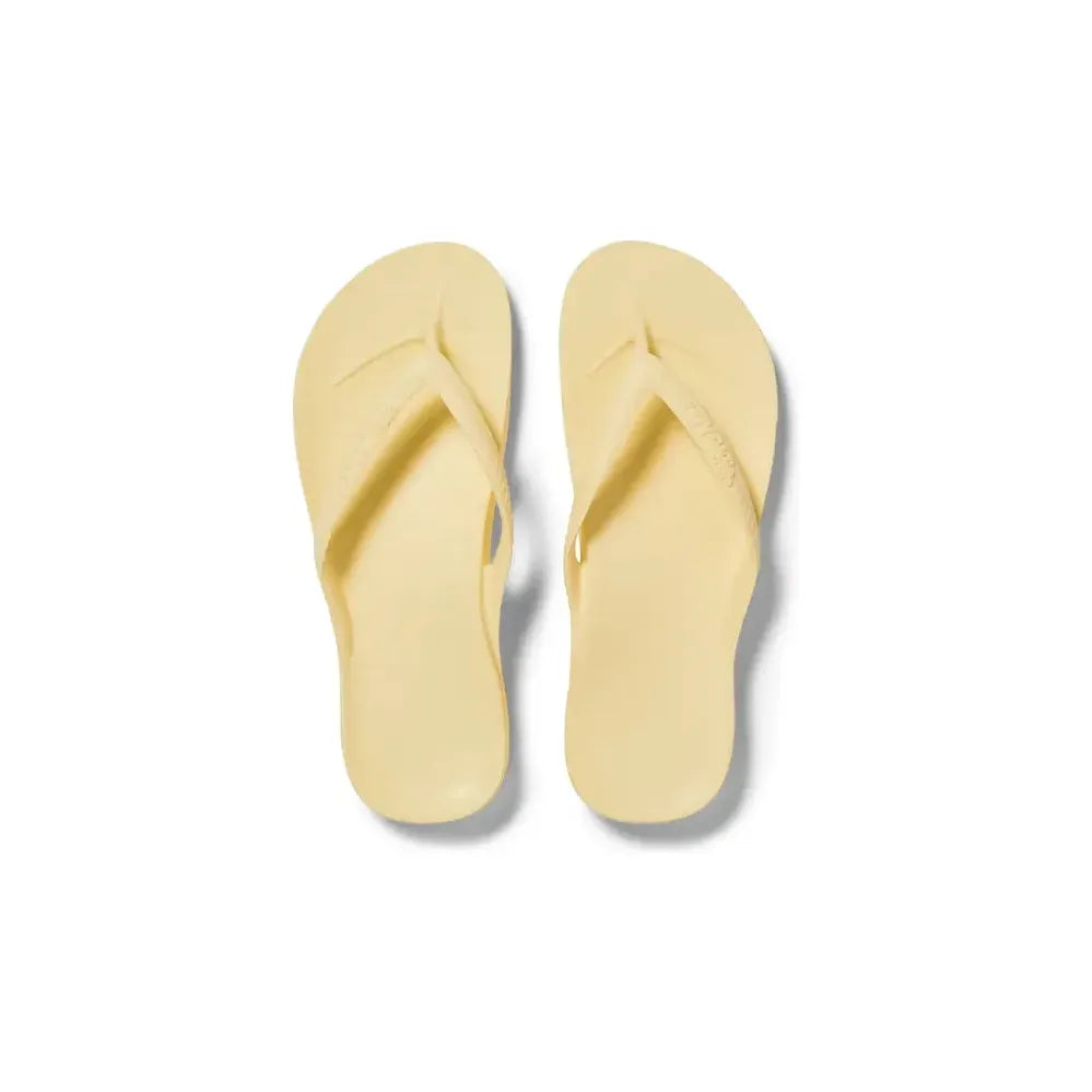 Archies M6/W7 footwear featuring bright yellow lemon design on casual slip-on shoes with rubber soles.