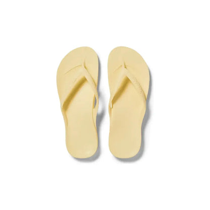 Archies M6/W7 footwear featuring bright yellow lemon design on casual slip-on shoes with rubber soles.