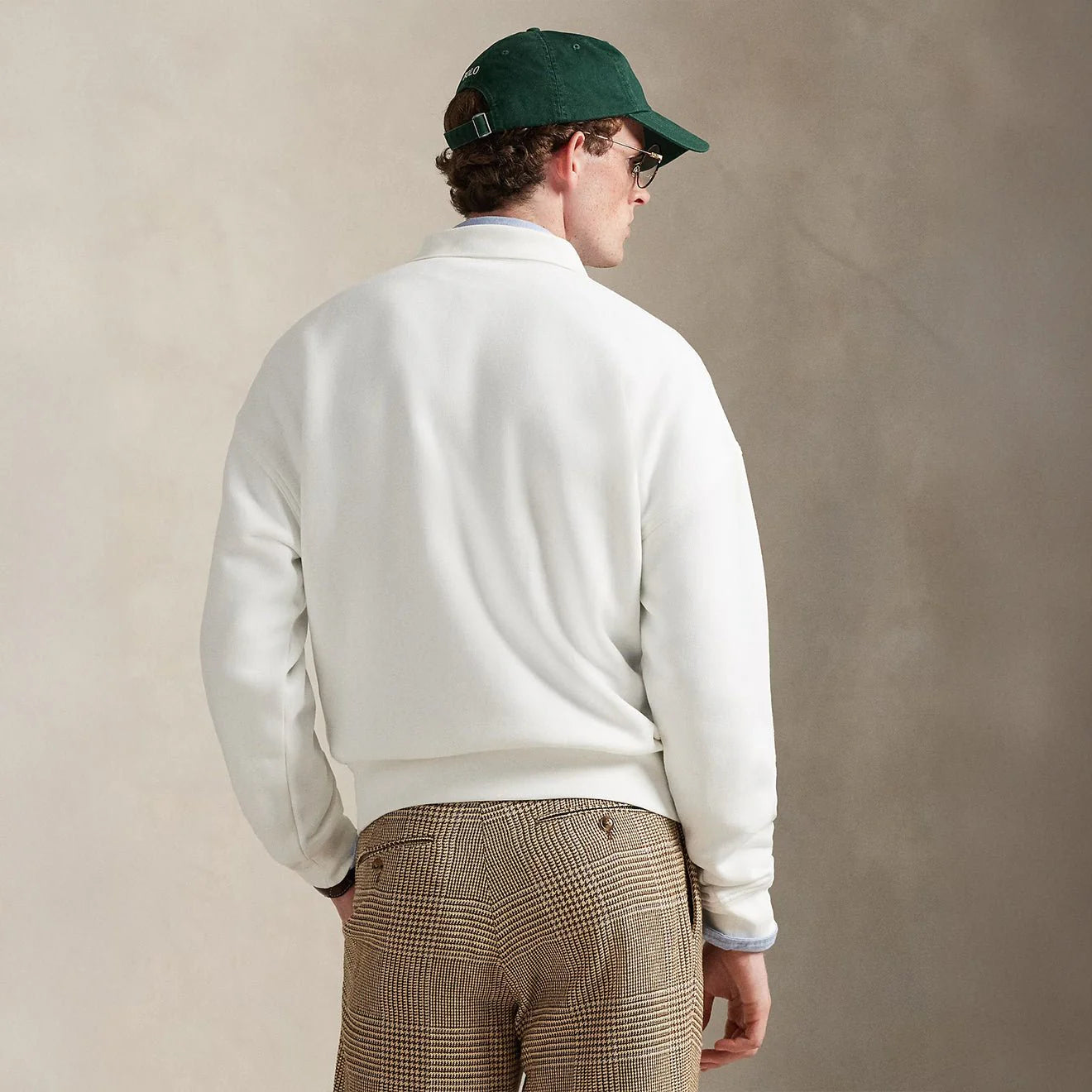 Men's white Polo Ralph Lauren Island Fleece graphic print polo sweatshirt showing relaxed fit and detailed graphic design.