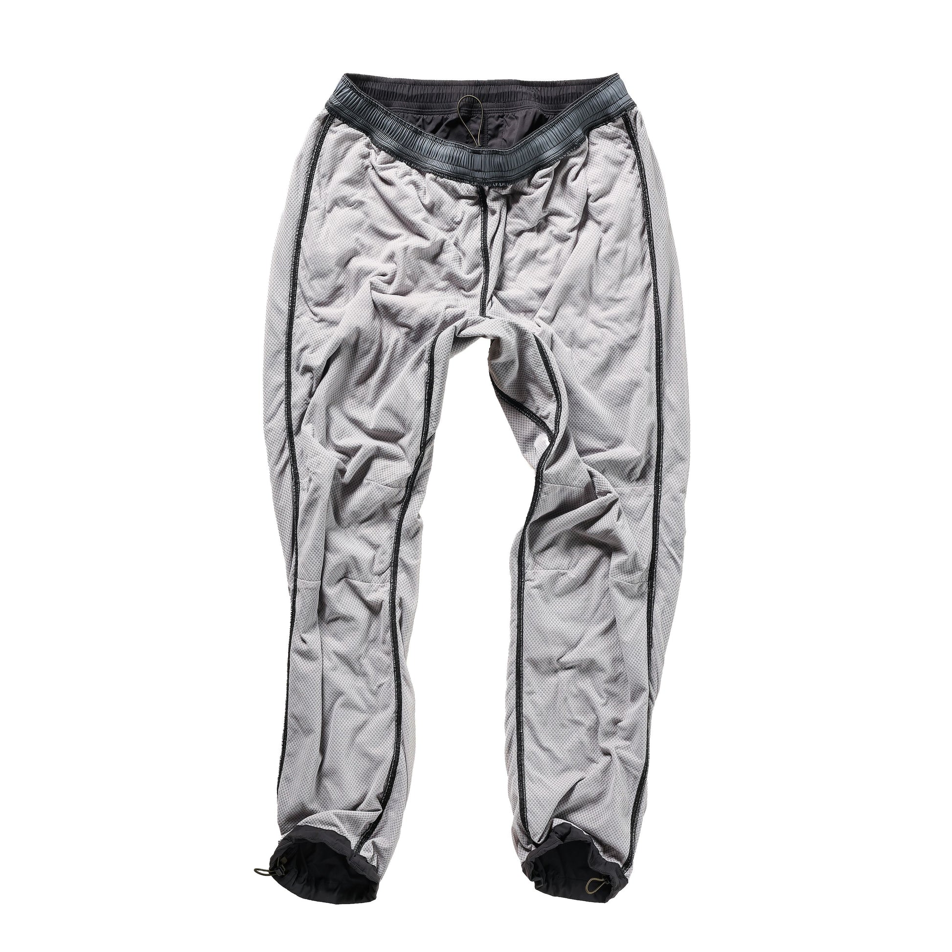 Men's black fade Off-Trail Windpant by Relwen, shown in a relaxed fit with adjustable waistband and tapered leg design.