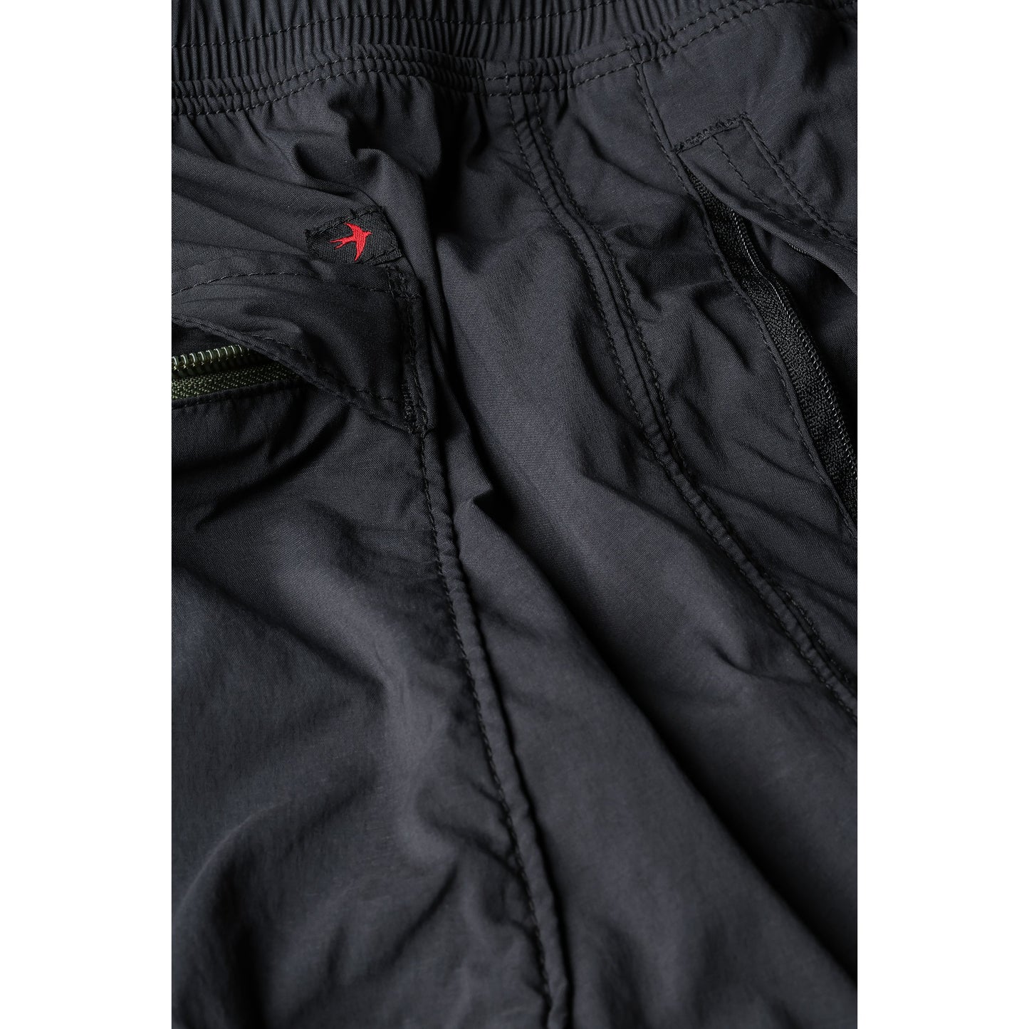 Men's Off-Trail Windpant by Relwen in black fade, showing lightweight, wind-resistant fabric and relaxed fit for outdoor activity.