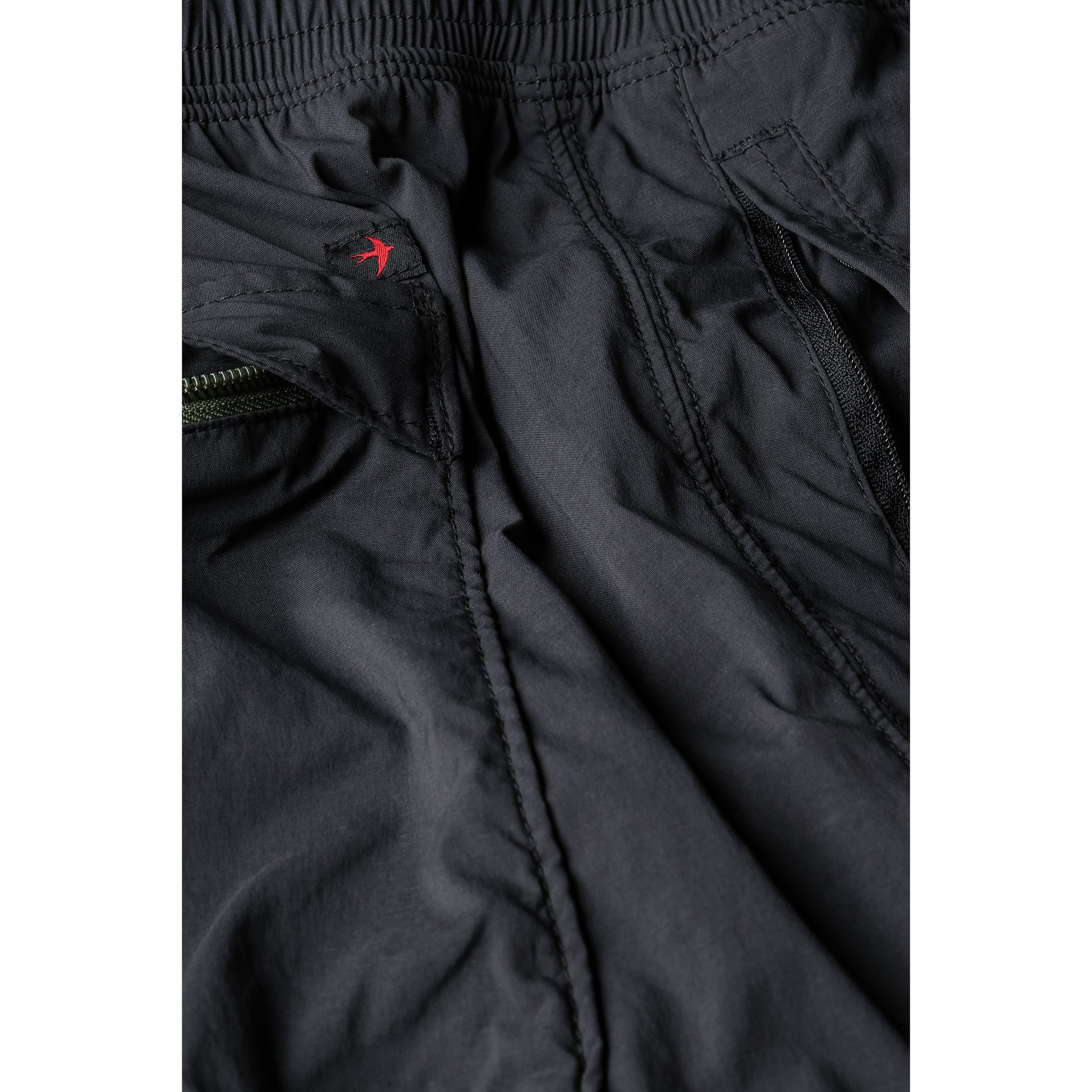 Men's Off-Trail Windpant by Relwen in black fade, showing lightweight, wind-resistant fabric and relaxed fit for outdoor activity.
