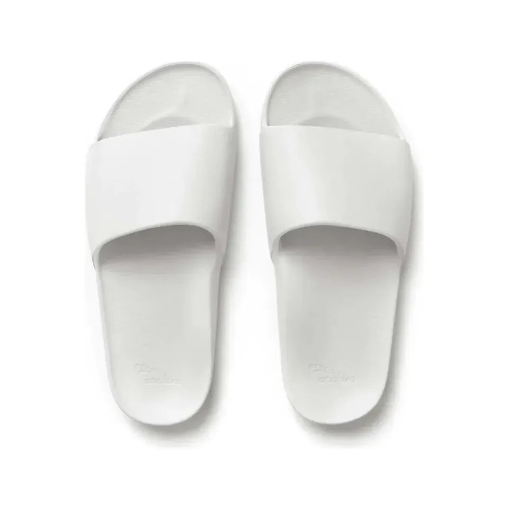 White slide sandals from Archies M8/W9 footwear collection, featuring a comfortable slip-on design and minimalist style.