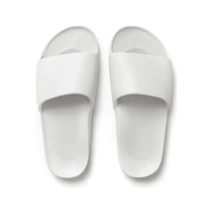 White slide sandals from Archies M8/W9 footwear collection, featuring a comfortable slip-on design and minimalist style.
