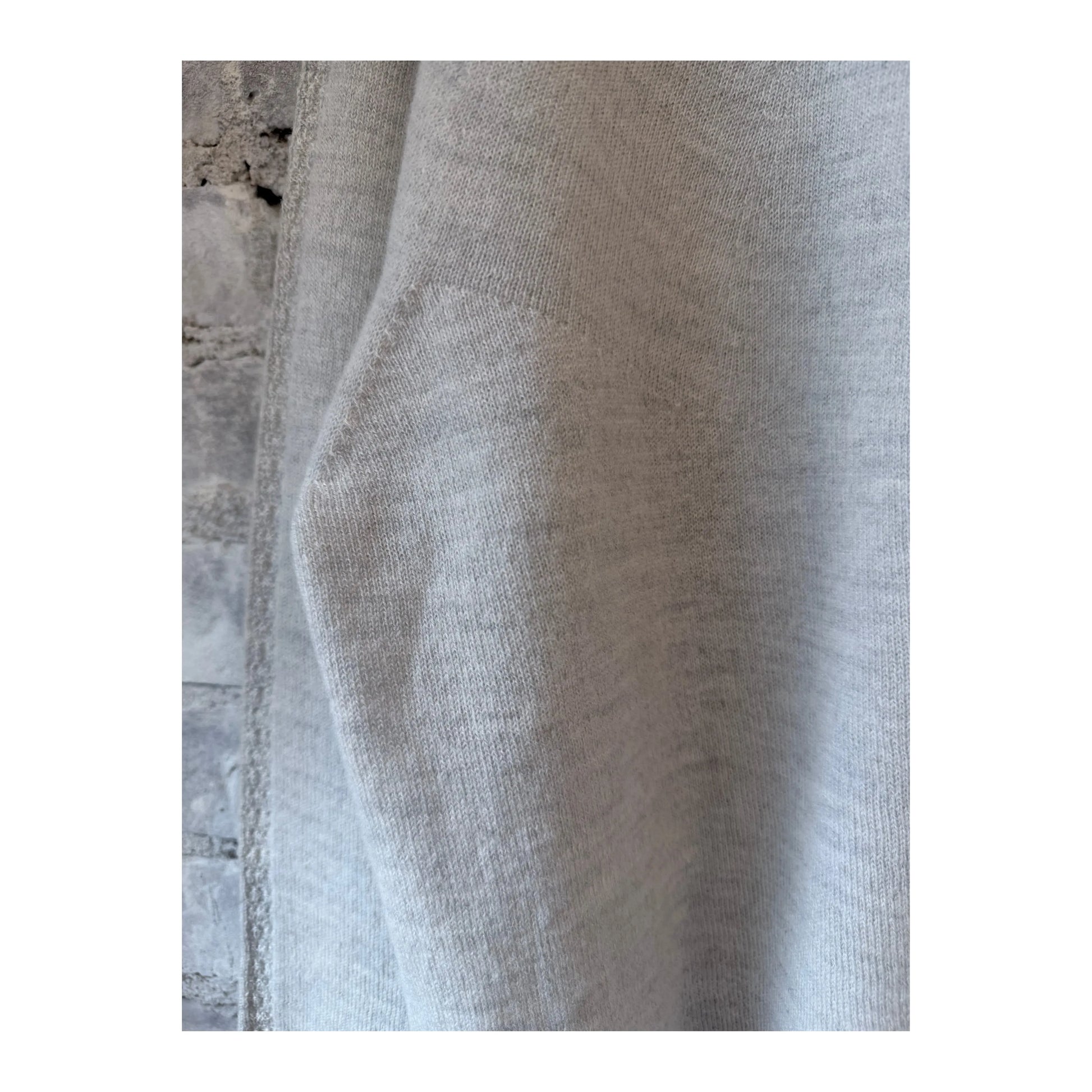 Light gray women's airy wool crewneck sweater by Pas De Calais, shown on a model with a relaxed fit and soft fabric texture.