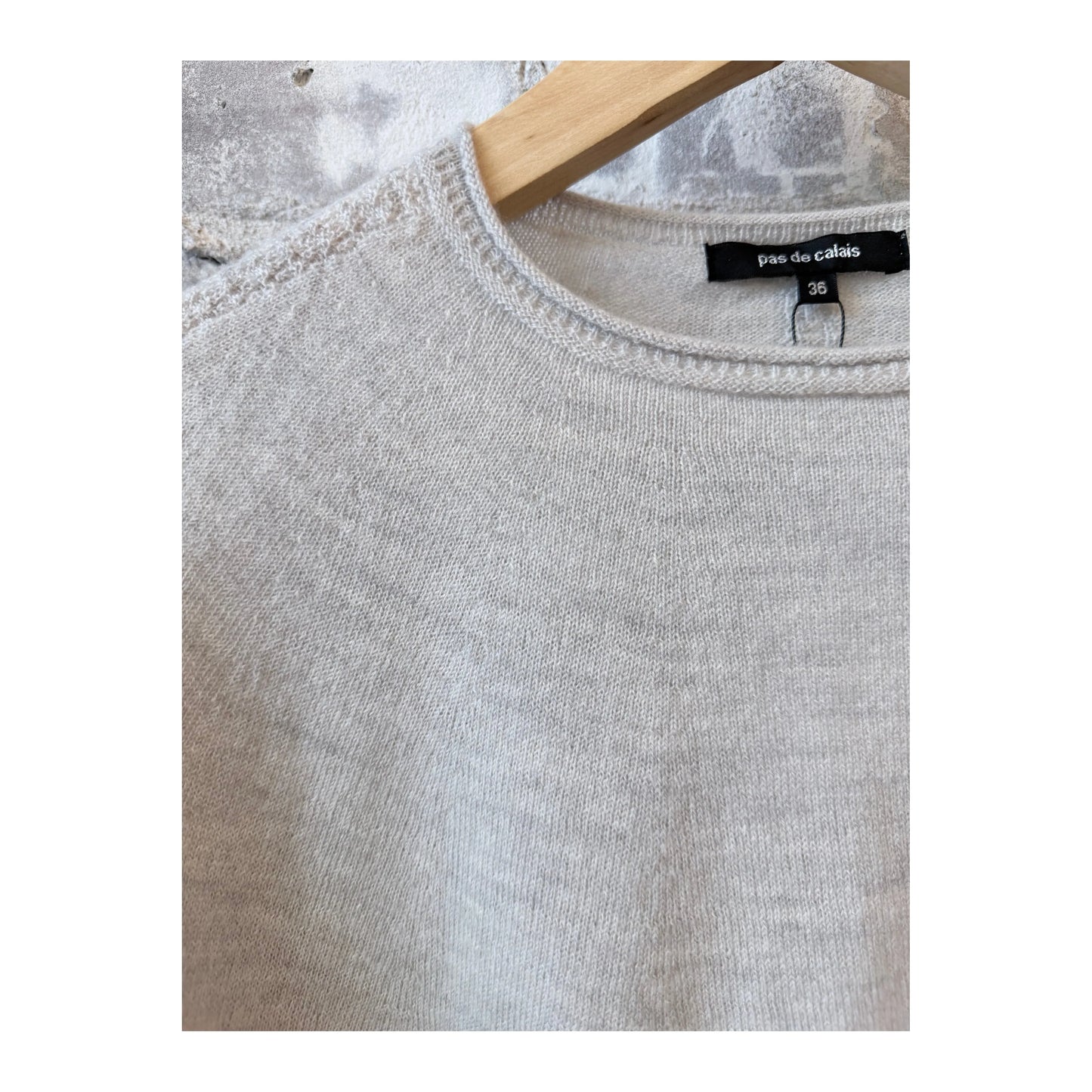 Light gray women's airy wool crewneck sweater by Pas De Calais, shown on a model, highlighting its soft knit texture.
