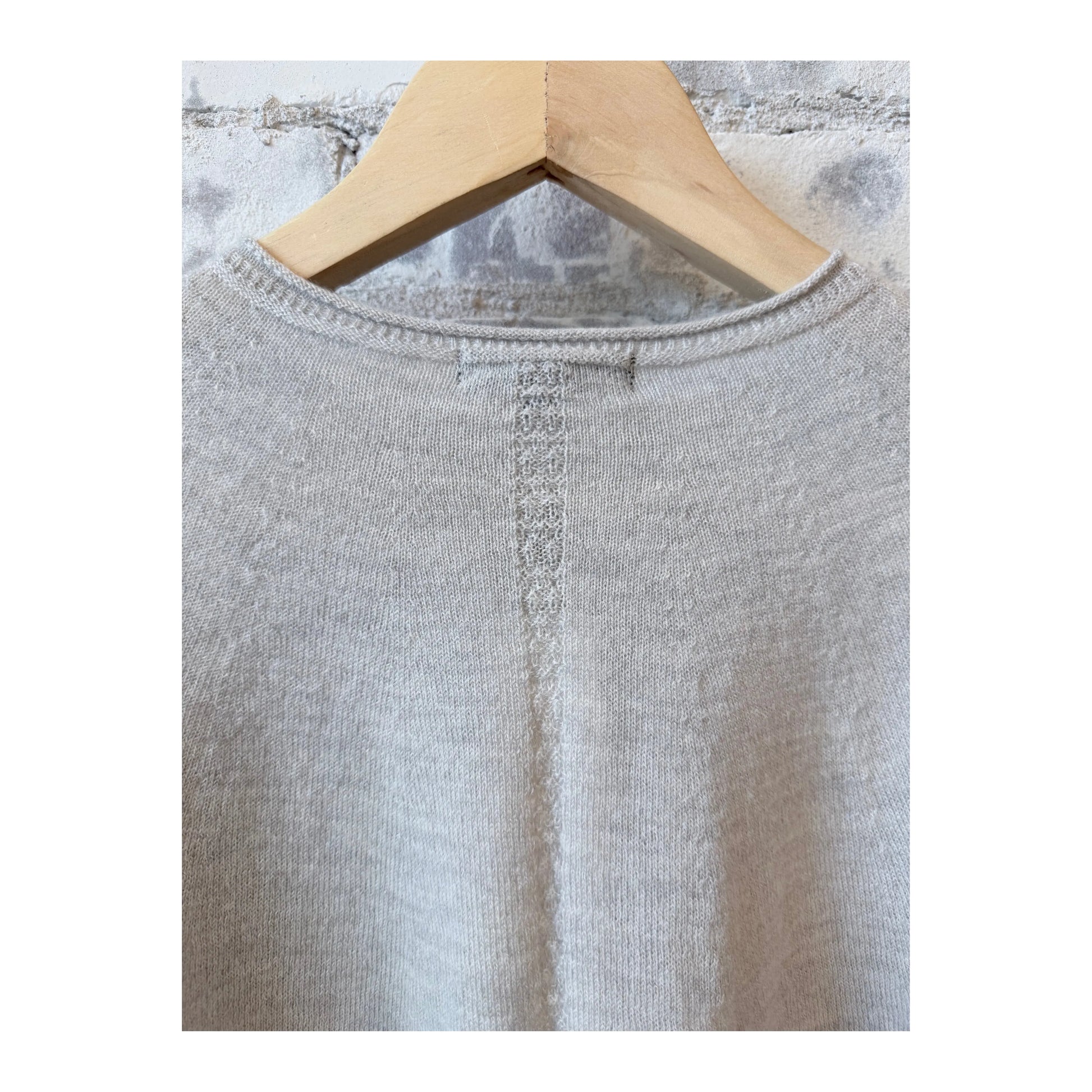 Light gray women's airy wool crewneck sweater by Pas De Calais, shown laid flat with soft knit texture.