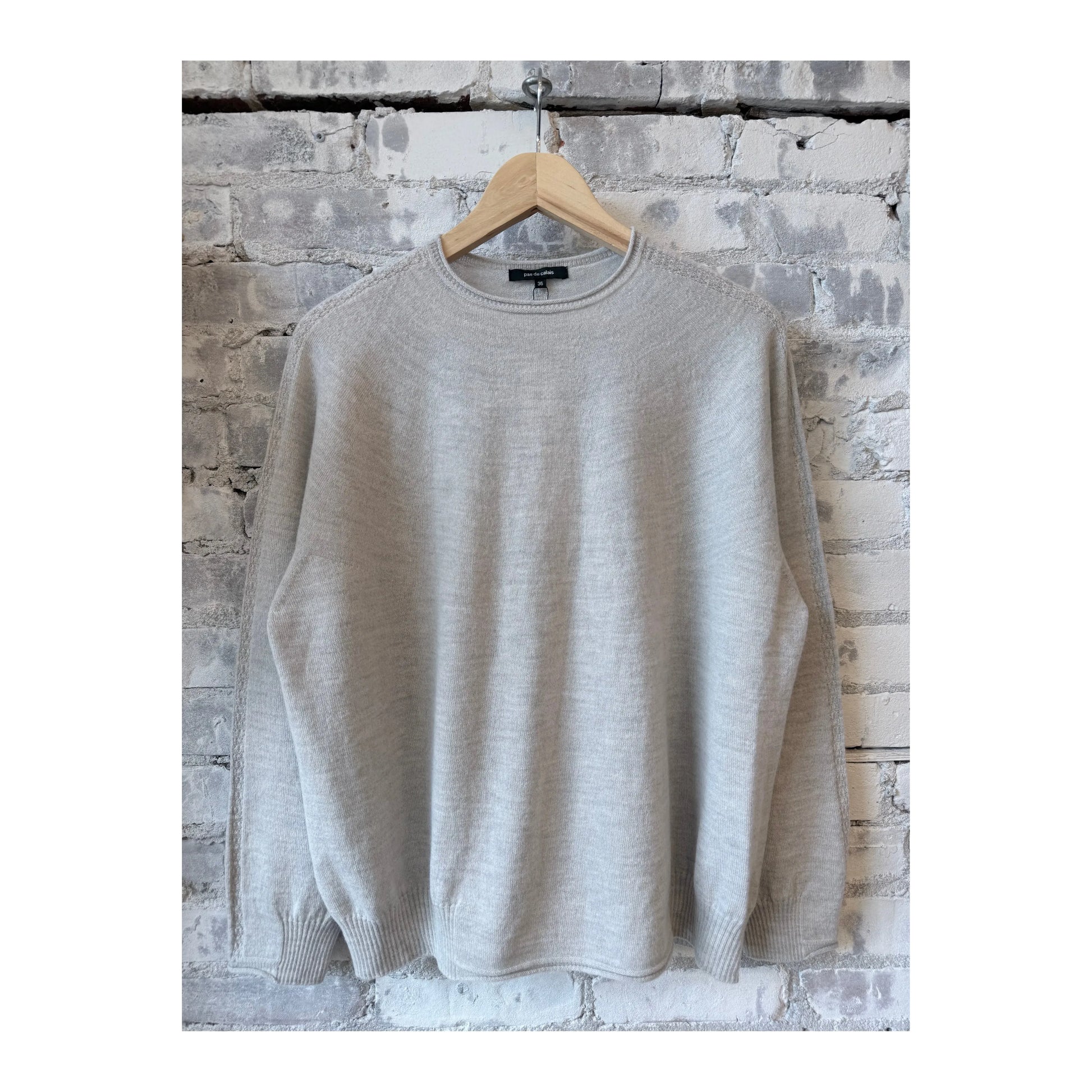 Light gray women's Airy Wool Crewneck Sweater by Pas De Calais, featuring a soft, comfortable fit and classic crewneck design.