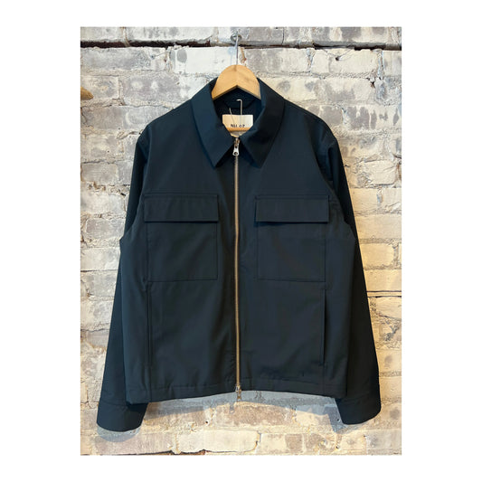 Men's navy blue Alban Technical Jacket by NN07, showcasing the lightweight, water-resistant outer layer with a full front zipper.
