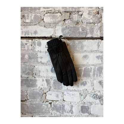 Women's black amber leather Hestra glove with detailed stitching and snug fit, designed for warmth and style.