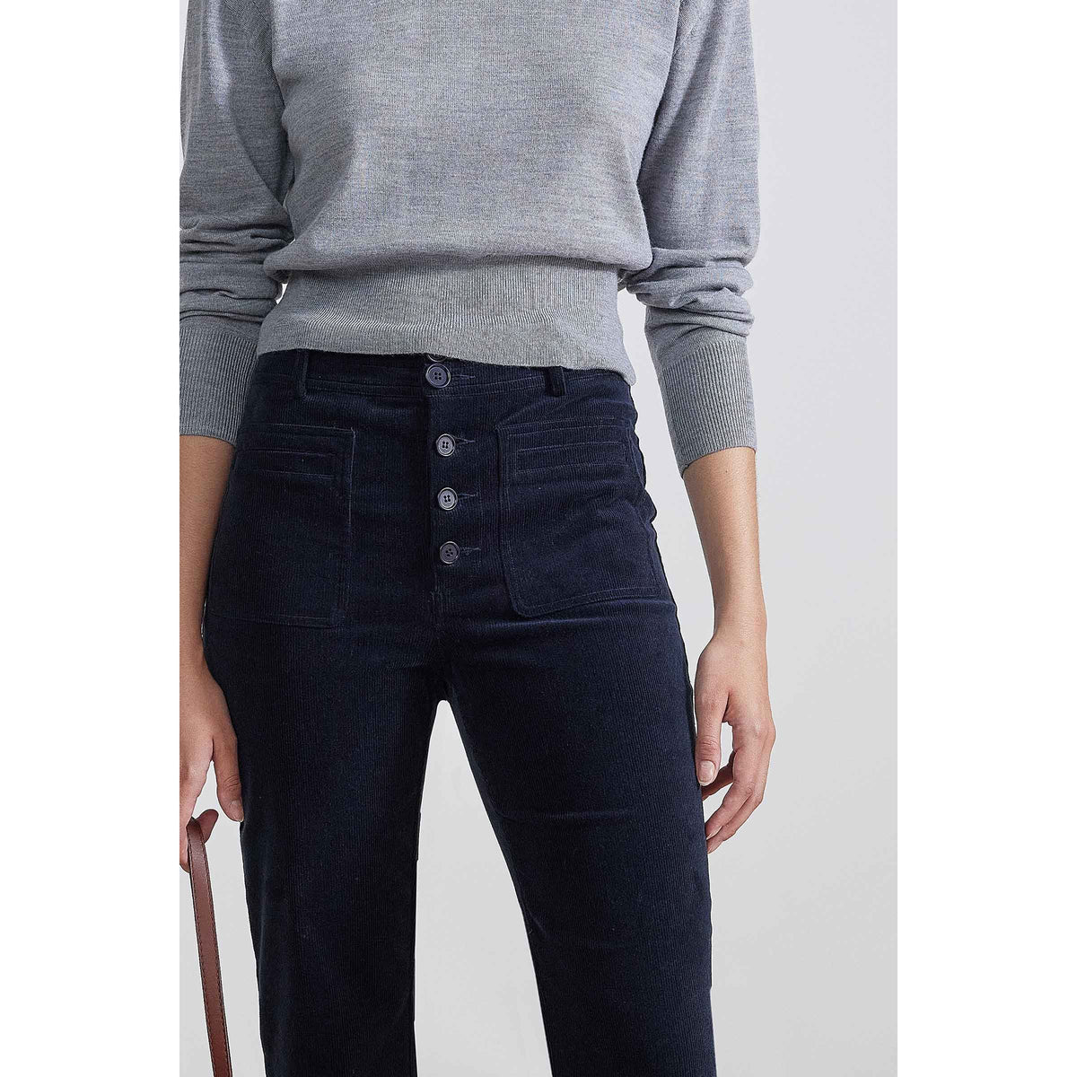 Women's midnight blue Marston Slim Corduroy Pant by Apiece Apart, showcasing fitted silhouette and textured fabric.