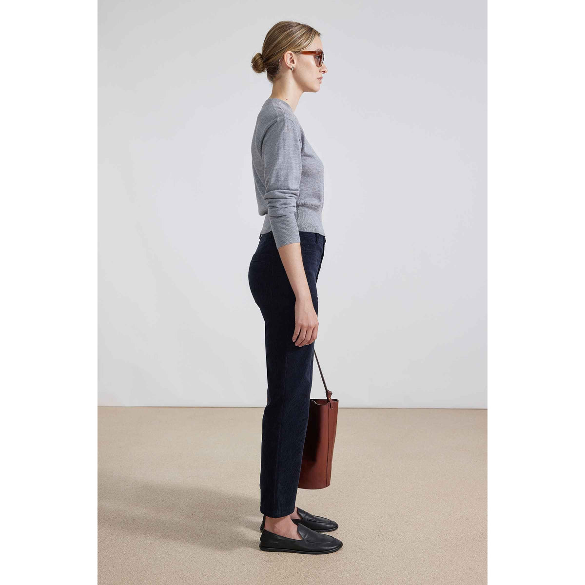 Women's Marston Slim Corduroy Pant in midnight blue by Apiece Apart, shown in a close-up of the fitted, textured fabric.