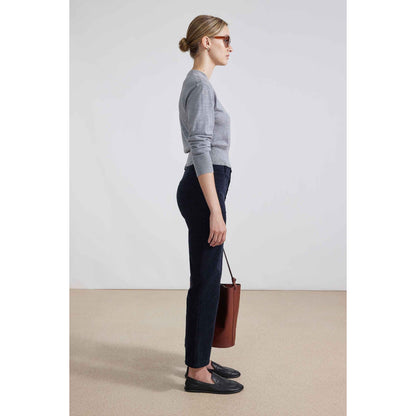 Women's Marston Slim Corduroy Pant in midnight blue by Apiece Apart, shown in a close-up of the fitted, textured fabric.