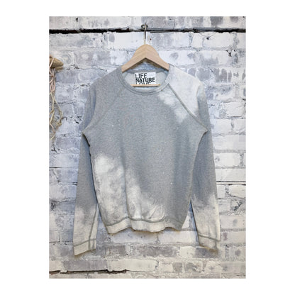 Women's Heather Bleachout raglan shirt by Freecity with heathered fabric and casual, relaxed fit, shown in a close-up image.