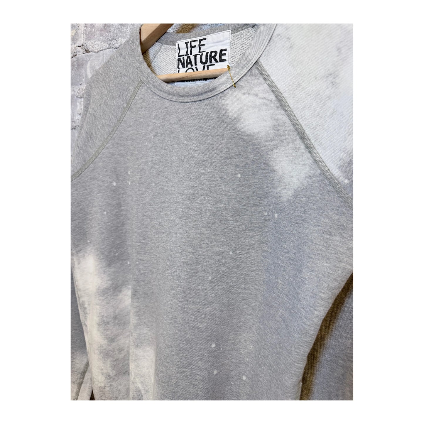 Women's Heather Bleachout raglan shirt by Freecity with heathered fabric and casual style, shown in the image.