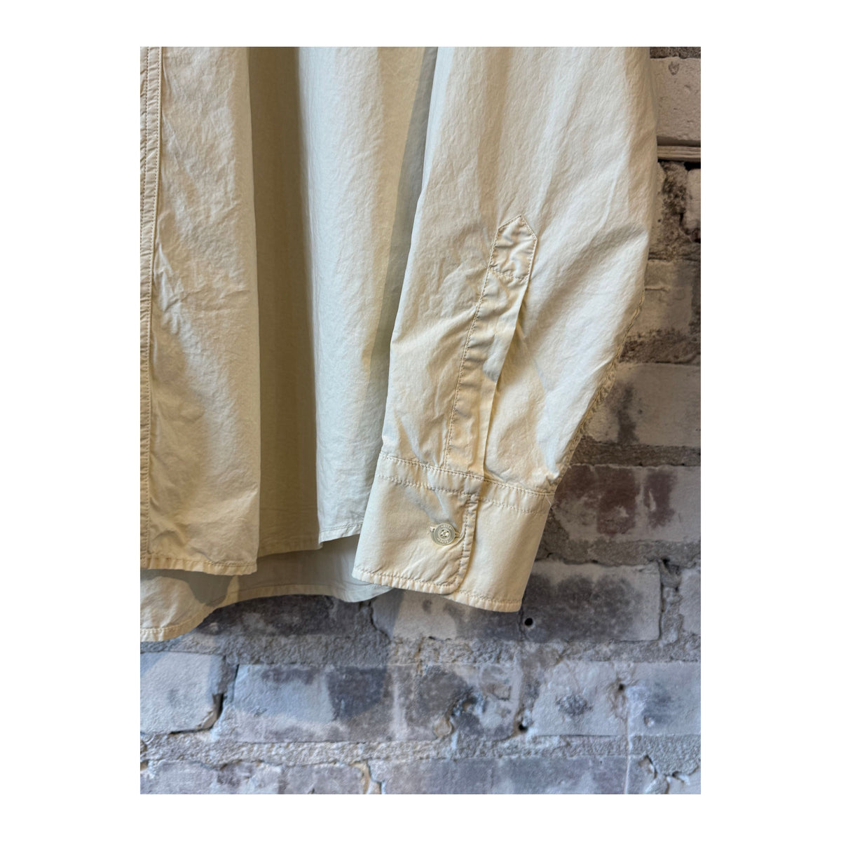 Men's Fred Garment-Dyed Shirt in sand color by Aspesi, showing the soft fabric, collar, and button details.
