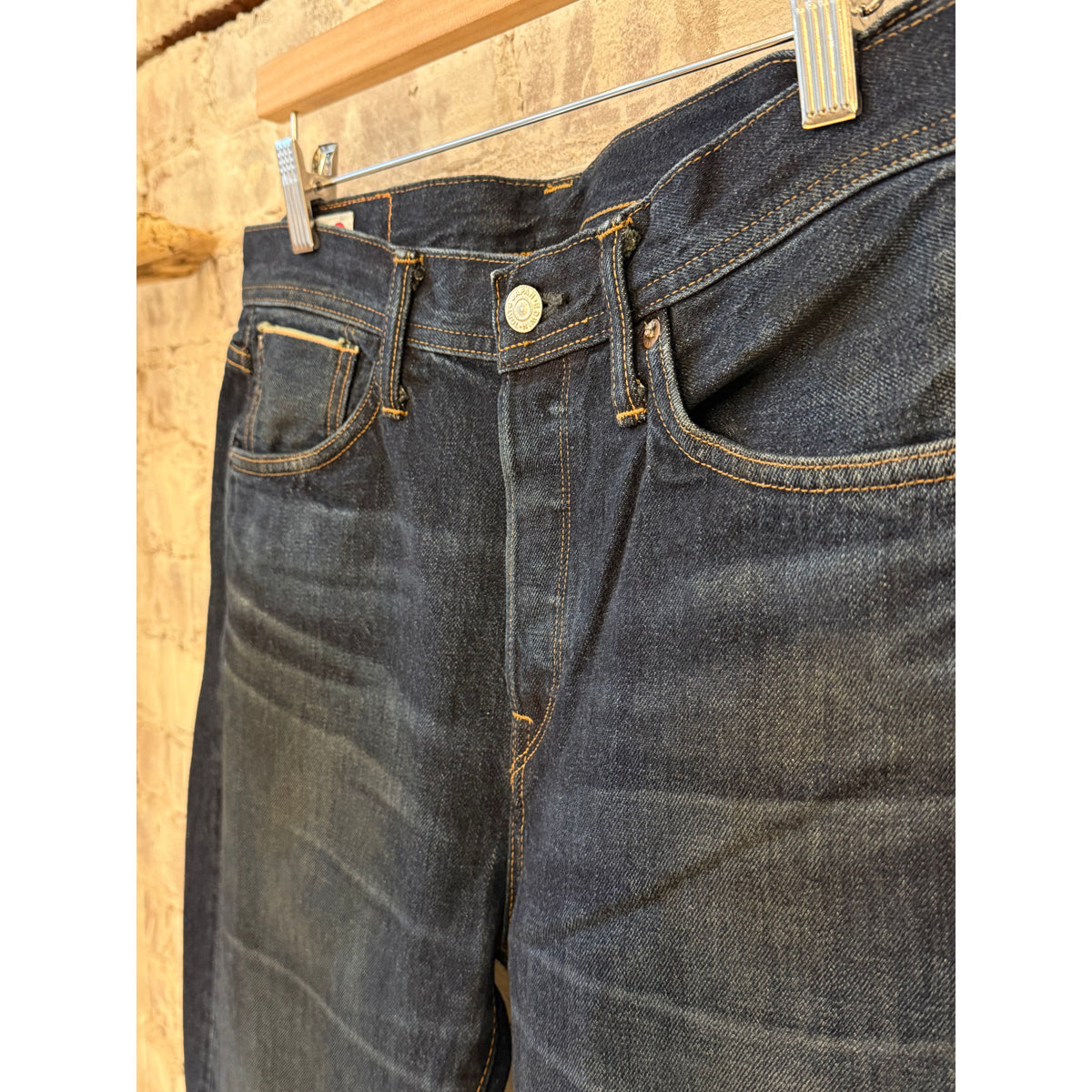 Men's Edwin Atika Straight 13.5oz Selvage denim jeans in dark wash with 90-day wash finish, shown hanging with visible details.