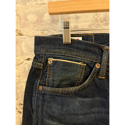 Men's Edwin Atika Straight 13.5oz selvage denim jeans in dark wash with 90-day wash fade, displayed hanging.