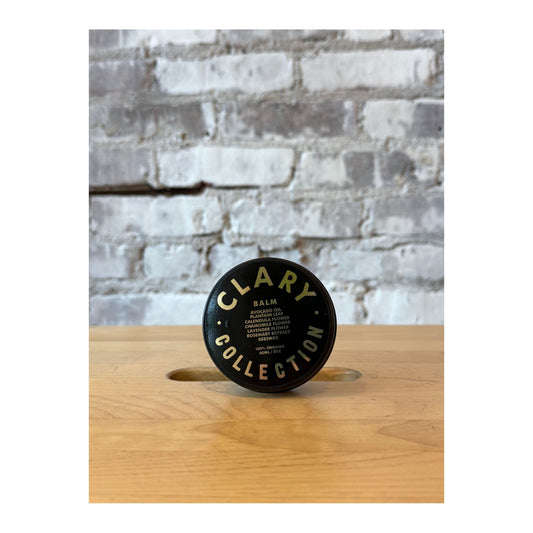 Clary Collection Avocado Balm 2oz in a small jar, natural skincare accessory with a green avocado-themed label and lid.