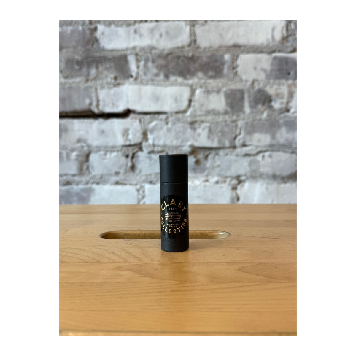 Clary Collection avocado balm stick in a small, portable .3oz accessories container with a green and white label.