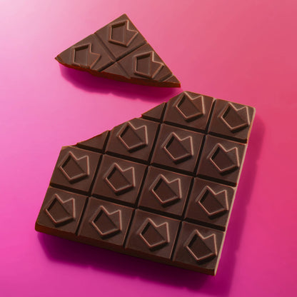 Eat Gold Organics BIG ORGASM chocolate bar accessory, showcasing the rich, delicious chocolate with a textured surface.